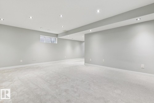 Spacious room featuring light gray carpeting, recessed ceiling lighting, a single window with blinds, and white baseboards - 4058 Morrison Way Nw, Edmonton, AB - Indoor Photo Showing Other Room