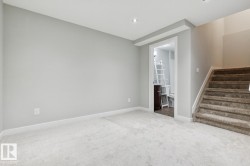 Carpeted room featuring light gray walls, white baseboards, and recessed lighting - 
