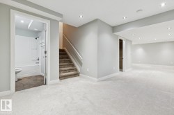 Spacious carpeted area with recessed lighting, painted walls, and white baseboards - 