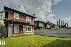 Two-story exterior with red horizontal siding and contrasting dark trim - 