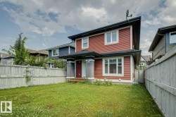 Red siding exterior with white window trim and a covered front entry - 