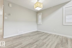 Light wood-finish flooring complements the neutral wall tones - 