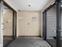 Entryway featuring double glass doors with metal frames and handles, recessed ceiling lighting, a security camera, and a tiled threshold - #220 245 Edwards Dr Sw, Edmonton, AB  -  Photo Showing Other Room 
