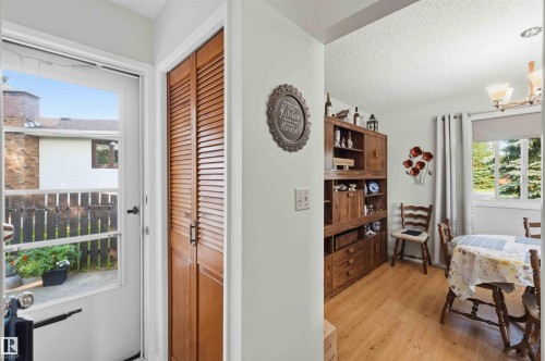 Wood-finish flooring with a side-by-side louvered closet - 30 Cavanagh Crescent, Stony Plain, AB - Indoor Photo Showing Dining Room