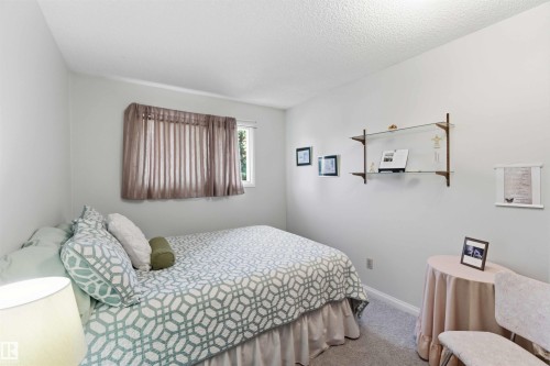 Wall-mounted shelving with glass shelves - 30 Cavanagh Crescent, Stony Plain, AB - Indoor Photo Showing Bedroom