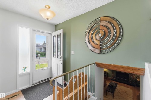 Entryway with wood-finish flooring, a glass-paneled entry door, and a sidelight window - 30 Cavanagh Crescent, Stony Plain, AB - Indoor Photo Showing Other Room