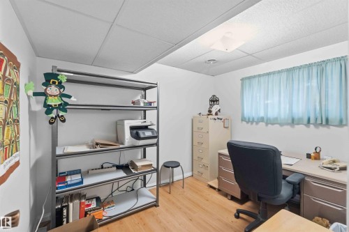 Recessed ceiling light, drop ceiling, wood-finish flooring, built-in shelving, window with curtain - 30 Cavanagh Crescent, Stony Plain, AB - Indoor Photo Showing Office