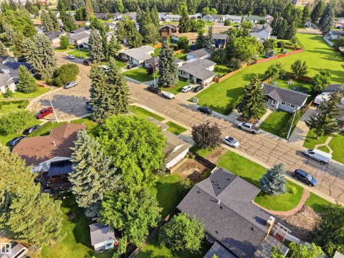 Residential neighborhood featuring mature trees, manicured lawns, and paved streets - 30 Cavanagh Crescent, Stony Plain, AB - Outdoor With View