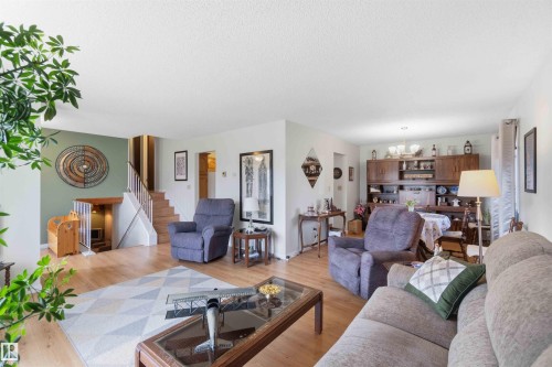 Wood-finish flooring throughout the main level - 30 Cavanagh Crescent, Stony Plain, AB - Indoor Photo Showing Living Room