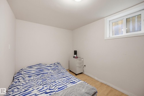 Bright room featuring light-toned walls and wood-finish flooring - 10714 103 Street Nw, Edmonton, AB - Indoor Photo Showing Bedroom