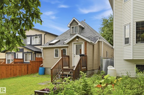 Rear exterior with a pitched shingle roof, dormer window, and skylights - 10714 103 Street Nw, Edmonton, AB - Outdoor