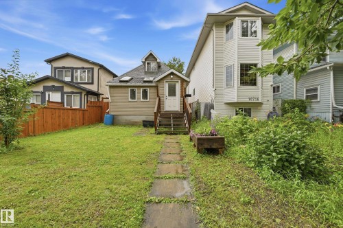 Rear exterior of the property featuring a wood staircase, two skylights, and a dormer window - 10714 103 Street Nw, Edmonton, AB - Outdoor
