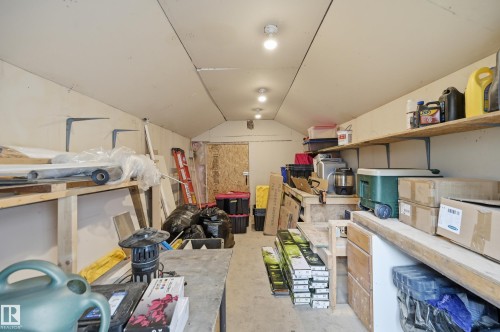Expansive storage area featuring sloped ceilings, recessed lighting, and extensive built-in shelving - 10714 103 Street Nw, Edmonton, AB - Indoor
