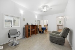 Bright living area featuring light-toned flooring and white walls - 