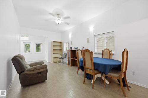 Open-concept room featuring light-toned flooring, white walls, and a ceiling fan with integrated lighting - 10714 103 Street Nw, Edmonton, AB - Indoor Photo Showing Other Room