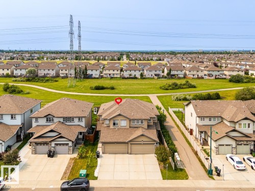 Aerial perspective highlighting the property's position within a residential development, featuring a two-story structure with a multi-gabled roofline - 1724 27 Street Nw, Edmonton, AB - Outdoor With View