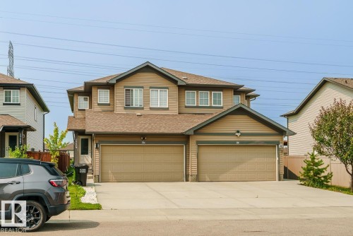Two-story residence featuring light brown horizontal siding with contrasting trim - 1724 27 Street Nw, Edmonton, AB - Outdoor