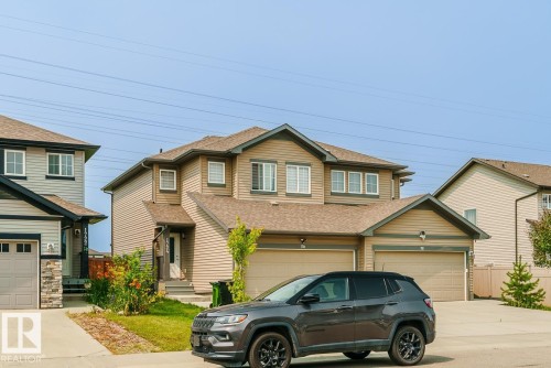 Two-story residence featuring light brown horizontal siding and a dark brown shingle roof - 1724 27 Street Nw, Edmonton, AB - Outdoor