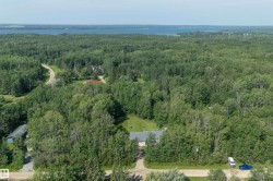 Aerial perspective showcasing a property surrounded by extensive natural woodlands - 