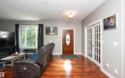 Warm wood-finish flooring complements the light gray wall tones - 