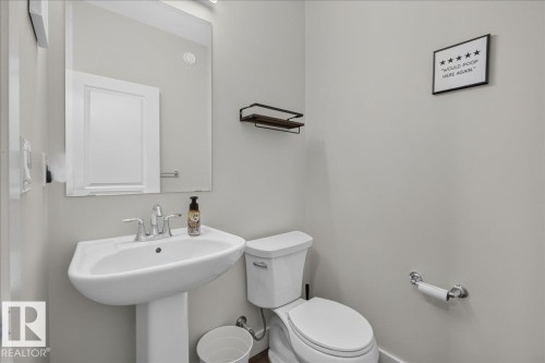 Pedestal sink with chrome faucet - 3805 Cherry Loop Sw, Edmonton, AB - Indoor Photo Showing Bathroom