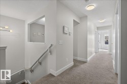 Carpeted hallway with flush-mount ceiling lighting - 