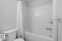 White bathtub-shower combination with a tiled surround - 