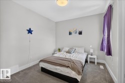 Neutral tone walls featuring white trim, gray carpet flooring, and a ceiling-mounted light fixture - 