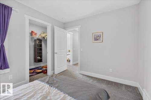 Carpeted room with light grey walls and white trim - 3805 Cherry Loop Sw, Edmonton, AB - Indoor Photo Showing Bedroom