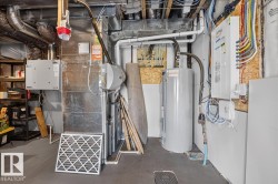Dedicated utility space featuring a furnace, water heater, and electrical panel - 