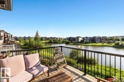 Expansive outdoor deck featuring wood-finish flooring and black metal railings - 