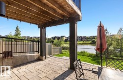 Covered patio with paver flooring and string lighting - 