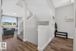 Warm wood-finish flooring extending into the open-concept living area - 