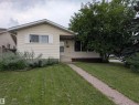 Ranch-style exterior with beige siding, a gabled roof, and white window shutters - 14228 22 Street Nw, Edmonton, AB  - Outdoor 