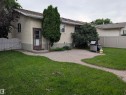 Expansive backyard featuring a manicured lawn, a gravel patio, and a privacy fence - 14228 22 Street Nw, Edmonton, AB  - Outdoor 