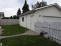 Detached garage with white siding, an overhead garage door, and a side entry door - 14228 22 Street Nw, Edmonton, AB  - Outdoor 