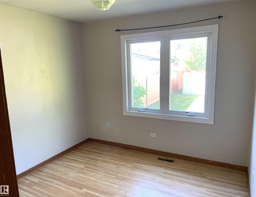 Interior room featuring hardwood flooring, a double window, and neutral wall tones - 11308 73 Avenue Nw, Edmonton, AB - Indoor Photo Showing Other Room