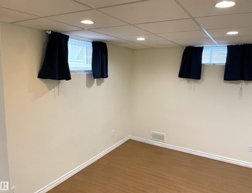 Interior space featuring light-toned walls, wood-finish flooring, and a grid-pattern drop ceiling with recessed lighting - 11308 73 Avenue Nw, Edmonton, AB - Indoor Photo Showing Other Room