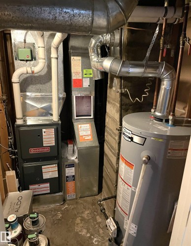 Utility area featuring a water heater, two furnaces, and extensive ductwork - 11308 73 Avenue Nw, Edmonton, AB - Indoor Photo Showing Basement