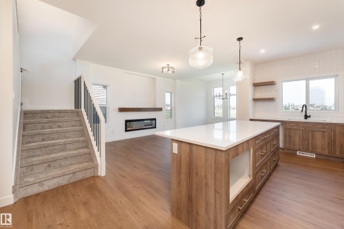 18 Tenuto Link, Spruce Grove, AB - Indoor Photo Showing Kitchen With Fireplace