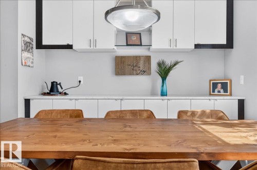 Built-in cabinetry featuring upper white wall cabinets and lower white base cabinets with dark trim - 3043 Keswick Way Sw, Edmonton, AB - Indoor