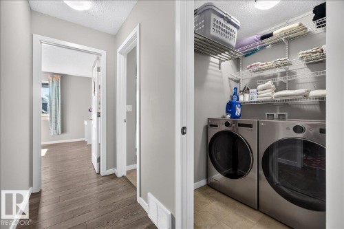 Dedicated laundry closet with wire shelving - 3043 Keswick Way Sw, Edmonton, AB - Indoor Photo Showing Laundry Room