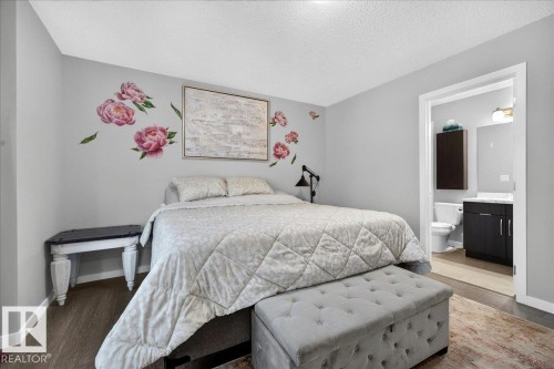 Bedroom with light gray walls and wood-finish flooring - 3043 Keswick Way Sw, Edmonton, AB - Indoor Photo Showing Bedroom