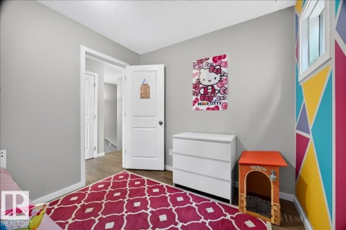 Room featuring light gray walls, wood-finish flooring, and white trim - 3043 Keswick Way Sw, Edmonton, AB - Indoor Photo Showing Bedroom