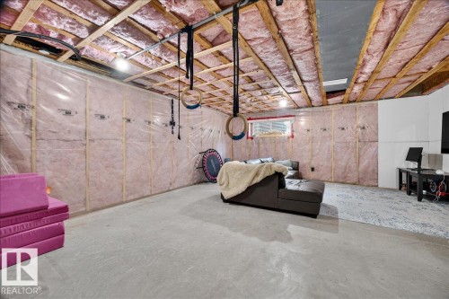 Unfinished basement with exposed ceiling joists and pink insulation - 3043 Keswick Way Sw, Edmonton, AB - Indoor Photo Showing Basement