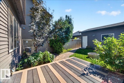 Multi-toned composite decking with a stone-paver pathway, leading to a detached structure with siding - 3043 Keswick Way Sw, Edmonton, AB - Outdoor