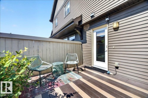 Private outdoor patio featuring multi-toned plank flooring and a wood fence - 3043 Keswick Way Sw, Edmonton, AB - Outdoor With Deck Patio Veranda With Exterior