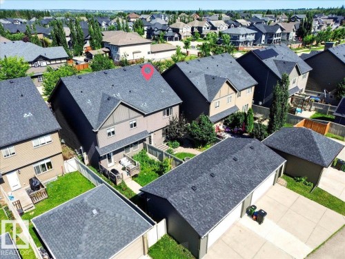 Two-story residential property with dark shingle roofing and a rear deck - 3043 Keswick Way Sw, Edmonton, AB - Outdoor