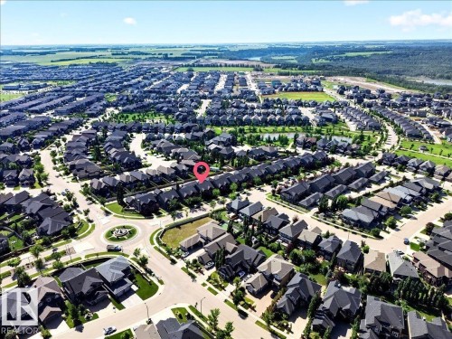 Aerial perspective showcasing a residential neighborhood with numerous detached homes, characterized by varied architectural styles and dark-toned roofing - 3043 Keswick Way Sw, Edmonton, AB - Outdoor With View