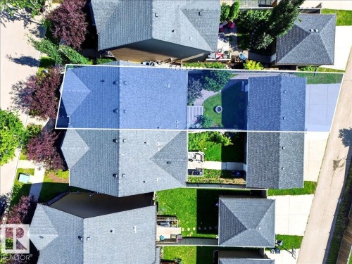 Aerial perspective showcasing a residential property with a shingle roof and a green lawn - 3043 Keswick Way Sw, Edmonton, AB - Outdoor